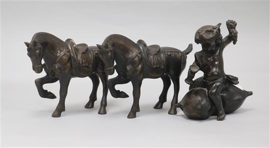 A pair of bronze horses and a bronze amorini